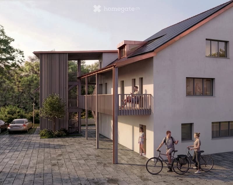 Modern two-story house with a balcony, light-colored facade, and a staircase leading to the upper level. There are two bicycles and a car parked nearby.