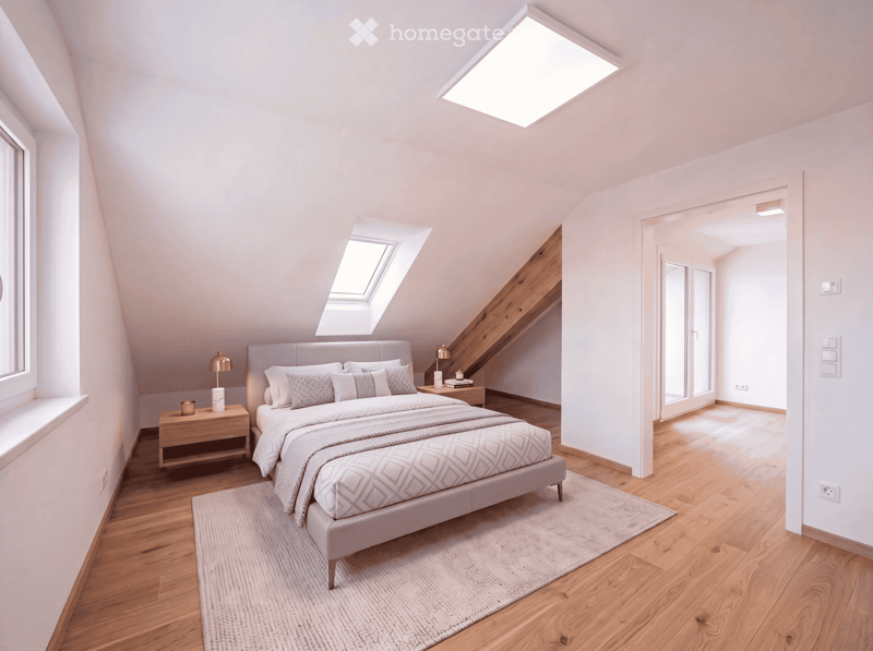 Modern bedroom with wooden flooring, white walls, large skylight, bed with grey bedding, nightstands, table lamps, and a small rug.