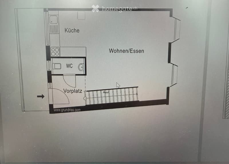Floor plan showing a kitchen, living/dining area, bathroom, and entrance area with a balcony.