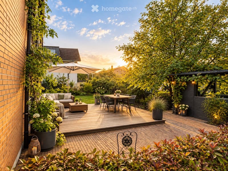 A well-maintained garden with a wooden deck, outdoor seating area, dining table, and lush greenery.