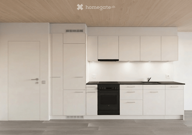 Modern, minimalist kitchen with white cabinets, black oven, and a sleek sink.