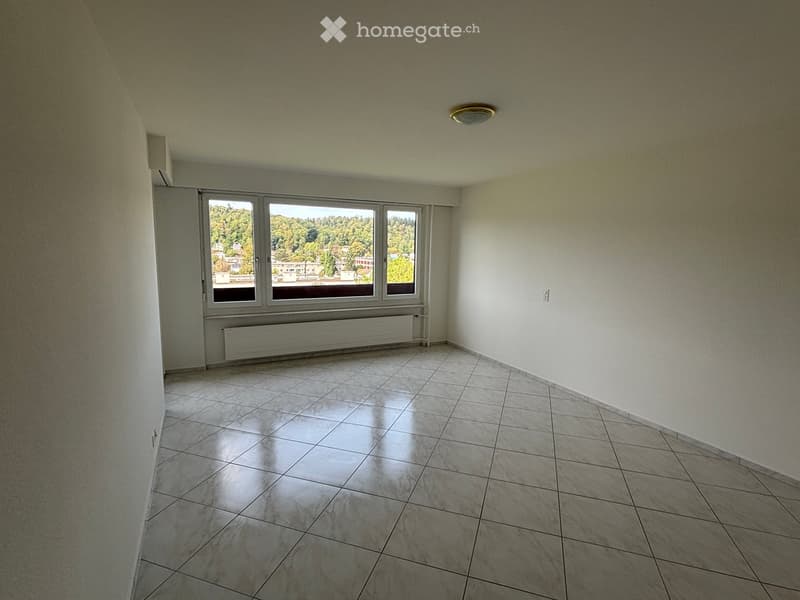 Empty room with tiled floor, large windows, and radiator under the windows.