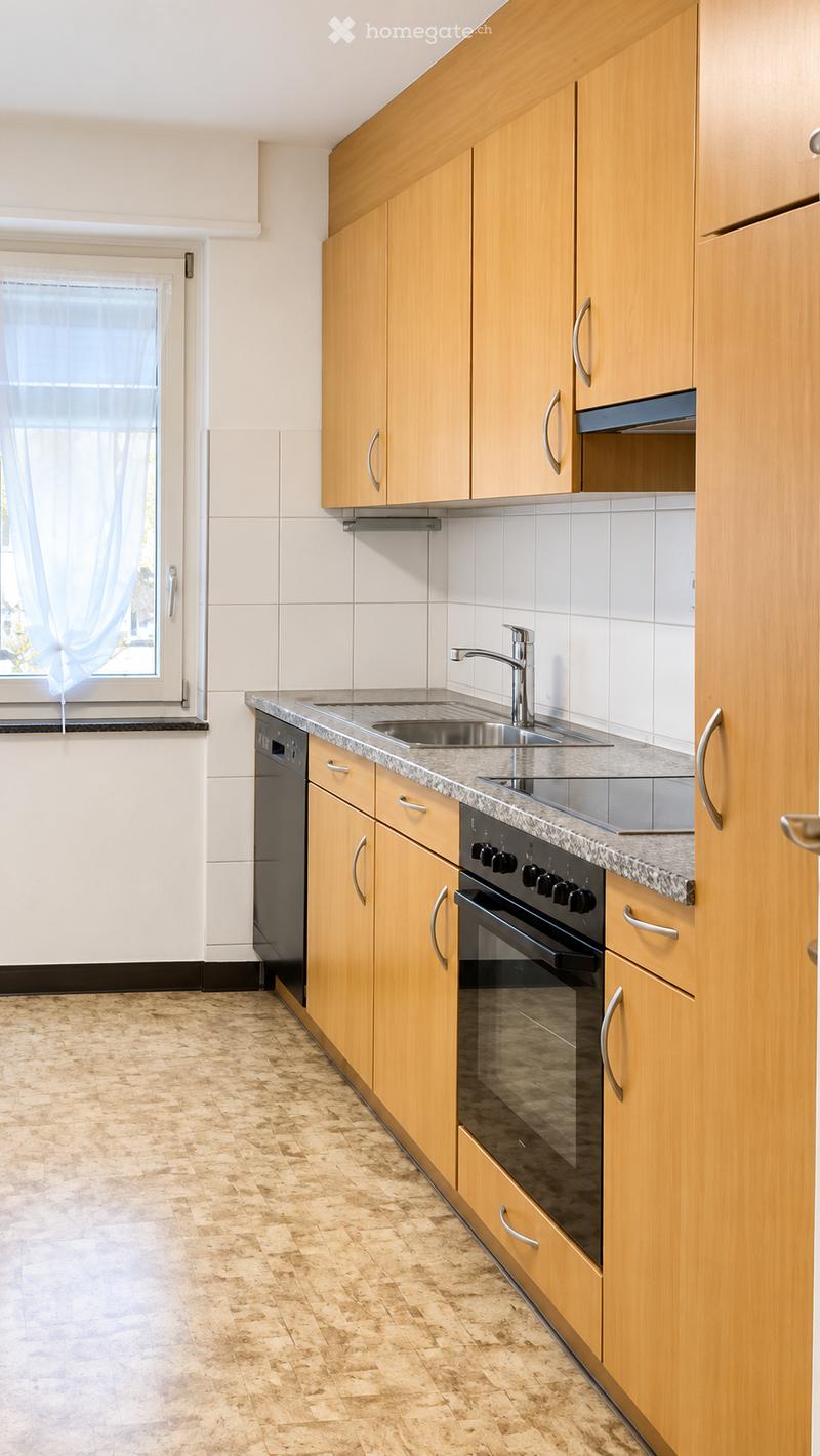 Modern kitchen with light wooden cabinets, granite countertop, stainless steel sink and faucet, built-in oven and dishwasher, and tiled backsplash.