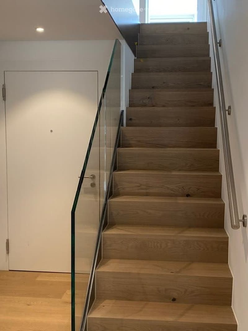 wooden stairs with glass railing