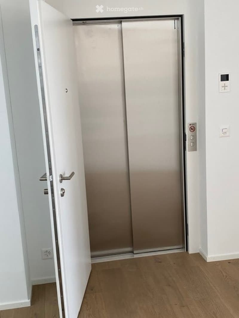Floor: Raised ground floor, silver elevator, tiled flooring, white walls