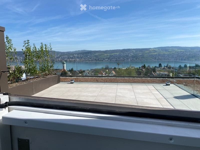 glass railing, tiled floor, overlooking city and lake