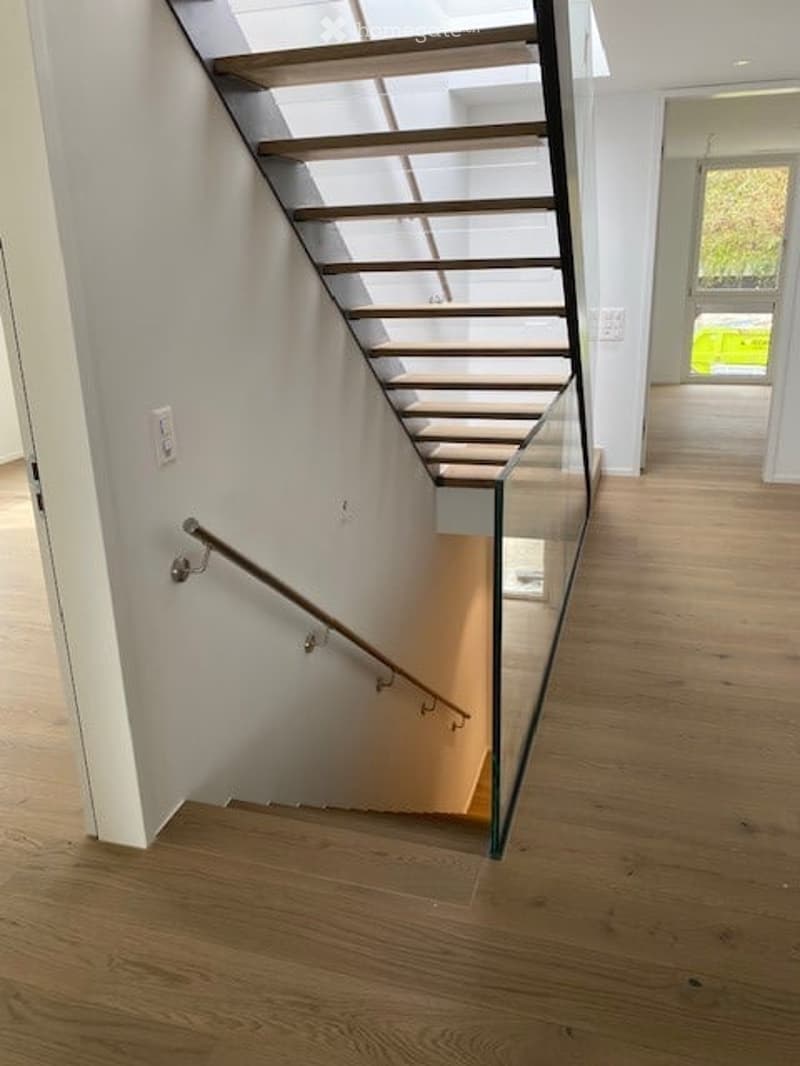 glass staircase, wooden handrail, wooden flooring, glass wall, white walls