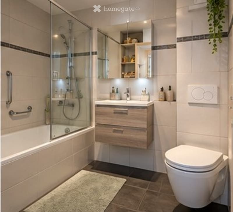 Modern bathroom with a bathtub, glass-enclosed shower, wooden vanity with sink, mirror, and toilet.