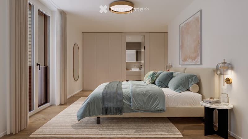 Modern bedroom with a large bed, nightstand, mirror, painting, and a small table with books and a glass.