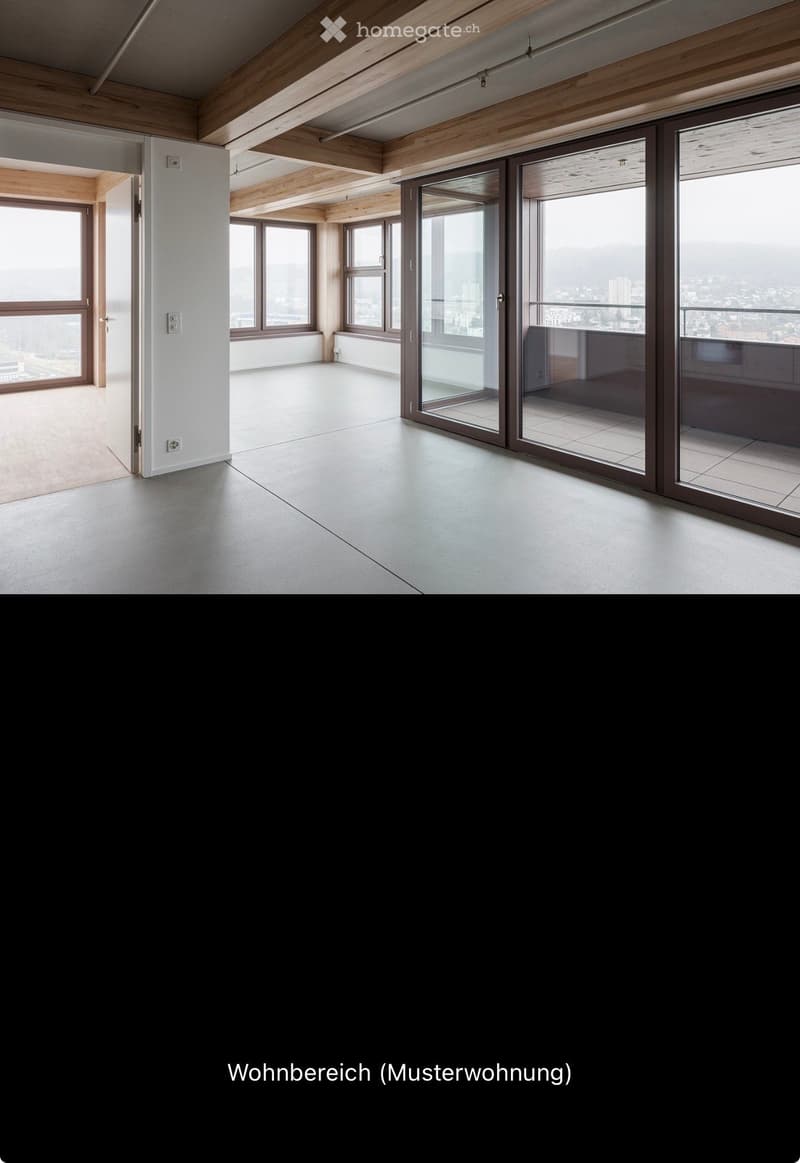 Empty room with wooden ceiling beams, large windows, and sliding glass doors leading to a balcony.
