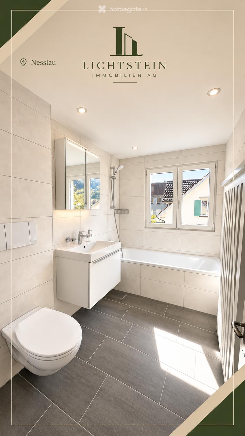 Modern bathroom with a white toilet, sink, bathtub, and large mirror. Grey tiled floor and white tiled walls.