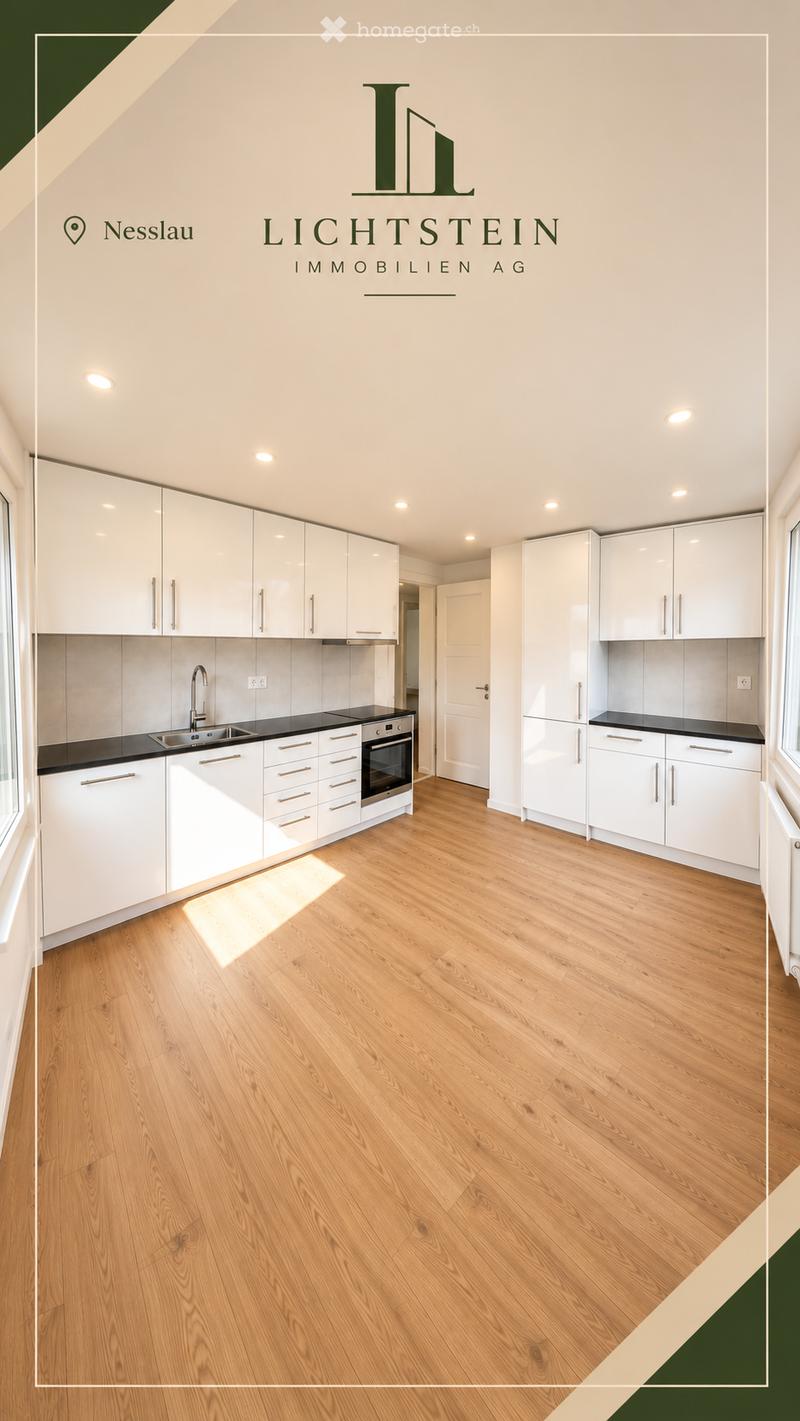 Modern kitchen with white cabinets, black countertops, wooden flooring, and integrated appliances including a sink, oven, and refrigerator.