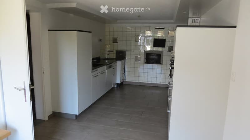 white cabinets, tile backsplash, modern stove, open floor plan, fireplace