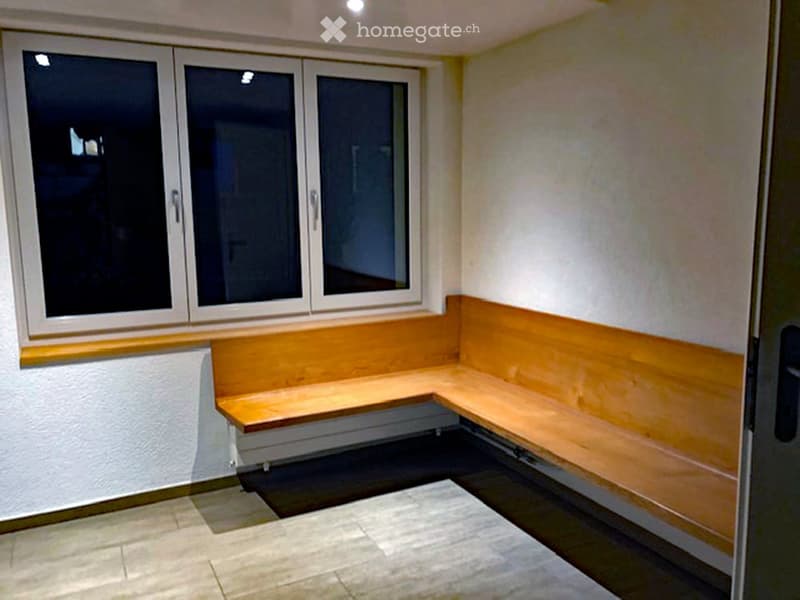 Window seating area, window with blinds, tiled floor, bench seating