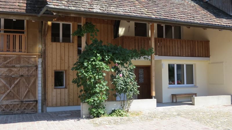 Wooden exterior, two floors, balcony, large wooden door