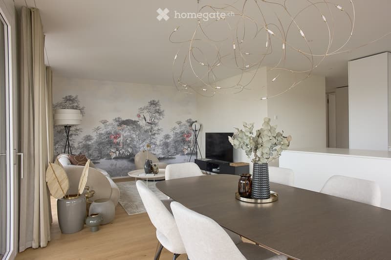 Modern living and dining area with a large abstract mural, a chandelier, a sofa, a dining table with chairs, and decorative vases.