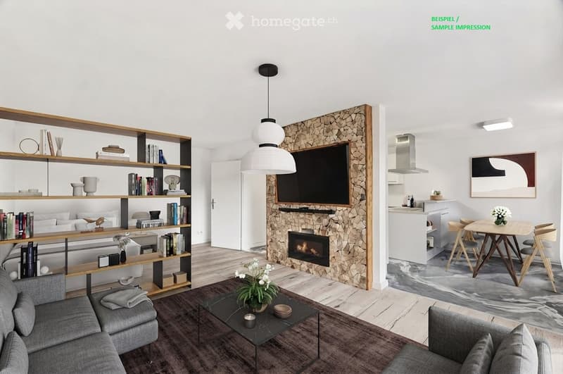 Modern living room with a grey sofa, coffee table, bookshelf, fireplace, and a small dining area with a table and chairs. The room features a pendant light and a wall-mounted TV.