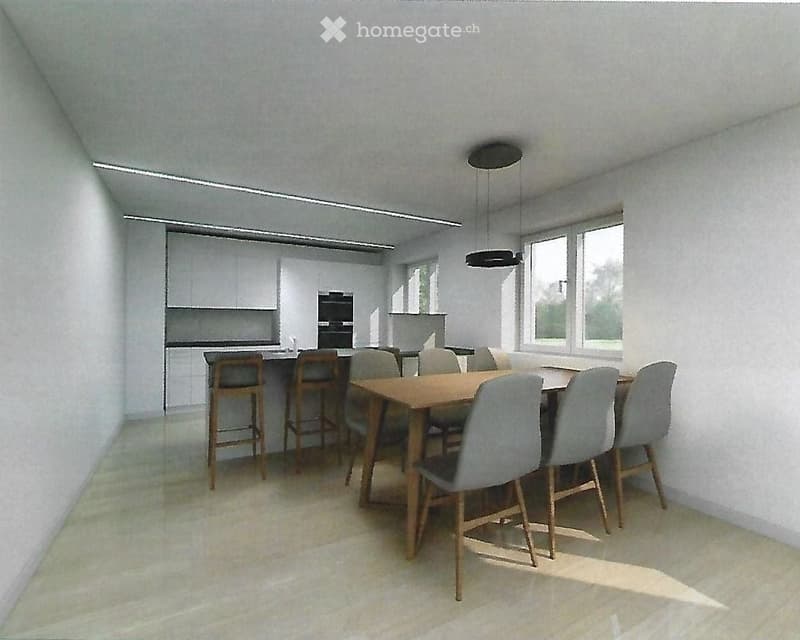 Open-plan kitchen and dining area with modern white cabinets, a wooden dining table surrounded by chairs and stools, and large windows allowing natural light.