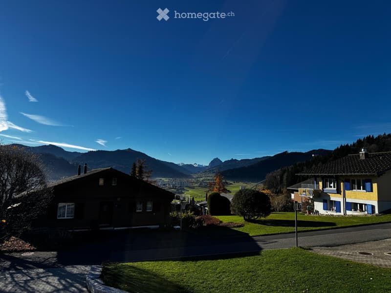 Countryside view with houses, mountains, and a valley
