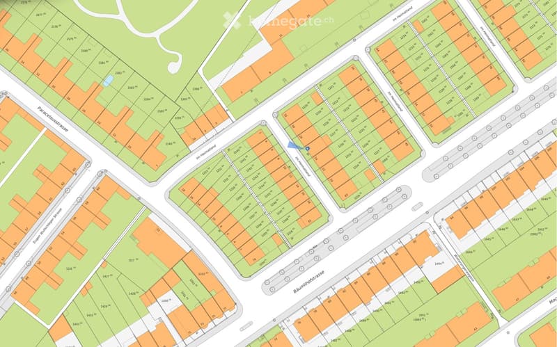 A detailed map showing a residential area with numbered plots, streets, and green spaces. The map includes labeled streets such as 'Im Heimatland', 'Baumhofstrasse', and 'Eugen-Wulff-Strasse', with various plot numbers and measurements indicated.