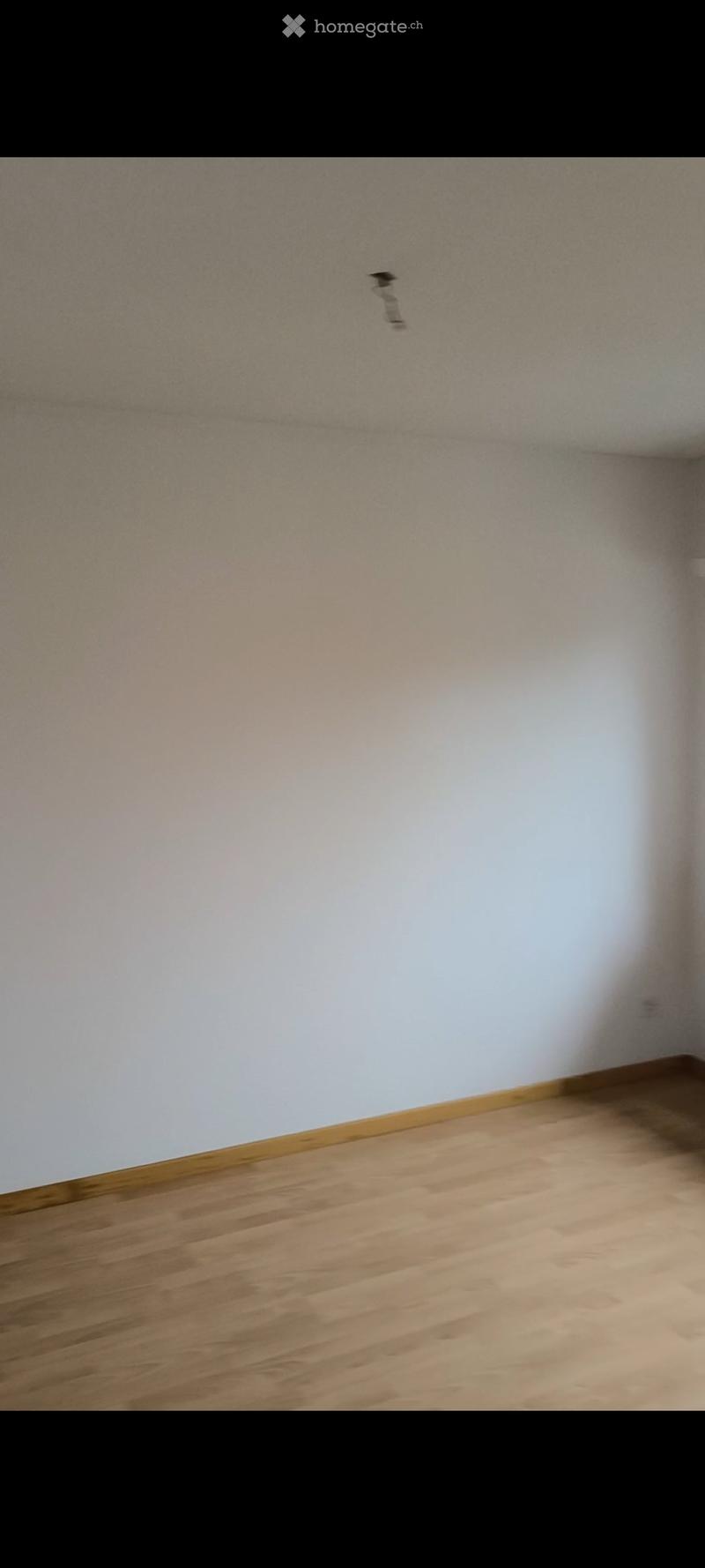 Empty room with wooden flooring and white walls, no furniture or equipment visible.