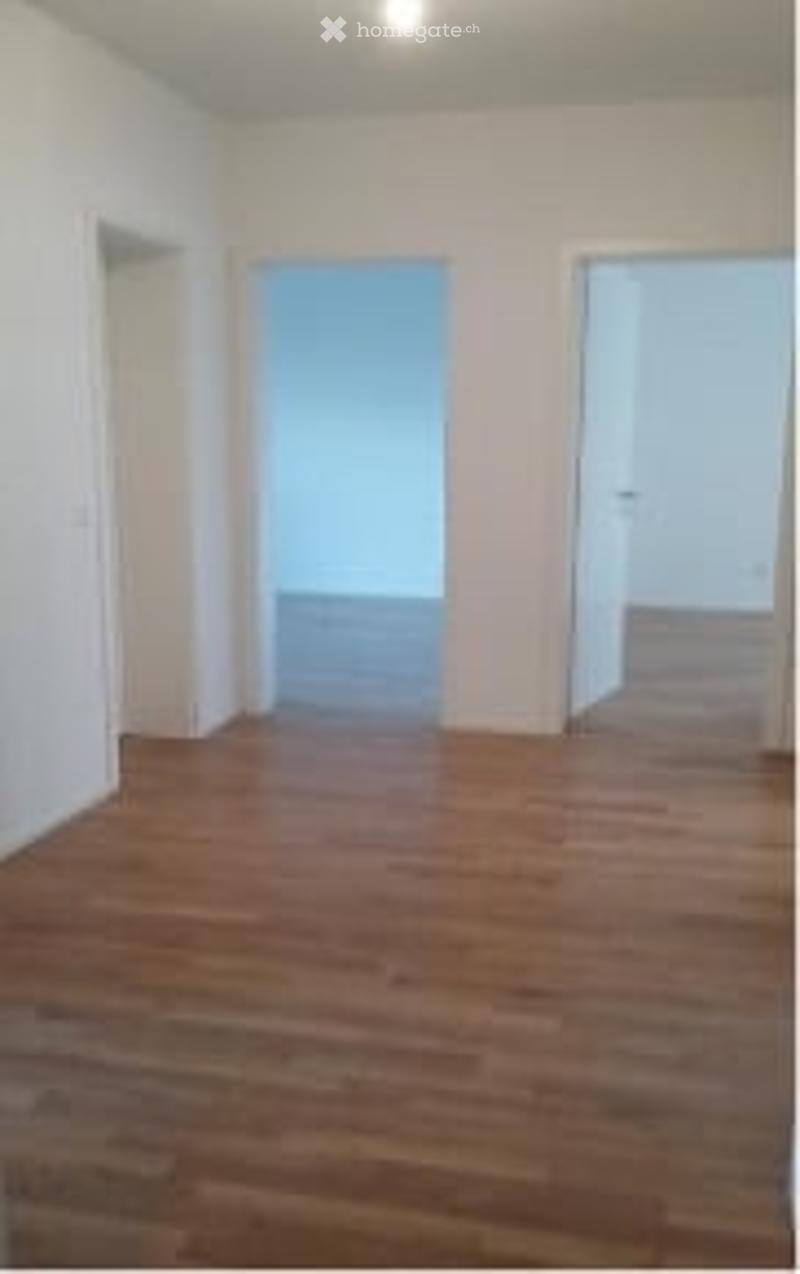 Completely empty room with wooden flooring and white walls. No furniture or equipment.