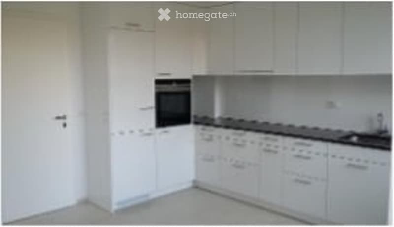 Modern kitchen with white cabinets, a stove, an oven, and a sink.