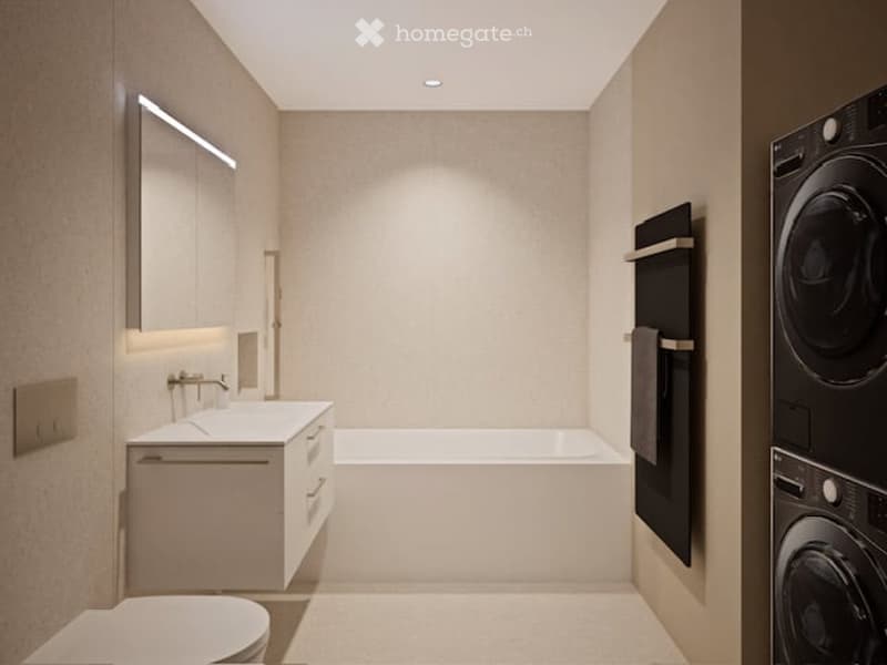 Modern bathroom with a white sink, bathtub, toilet, and a built-in washing machine. Features a sleek mirror with integrated lighting and a towel rack.