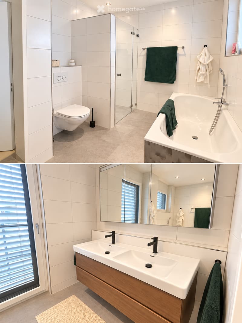 Modern bathroom with a toilet, bathtub, double sink, large mirror, and wooden cabinet. Green towels are neatly placed on the bathtub and sink.