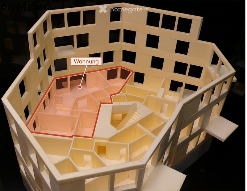 3D model of a multi-story building floor plan, showing a highlighted apartment unit with labeled rooms including a living area, bedroom, and bathroom.