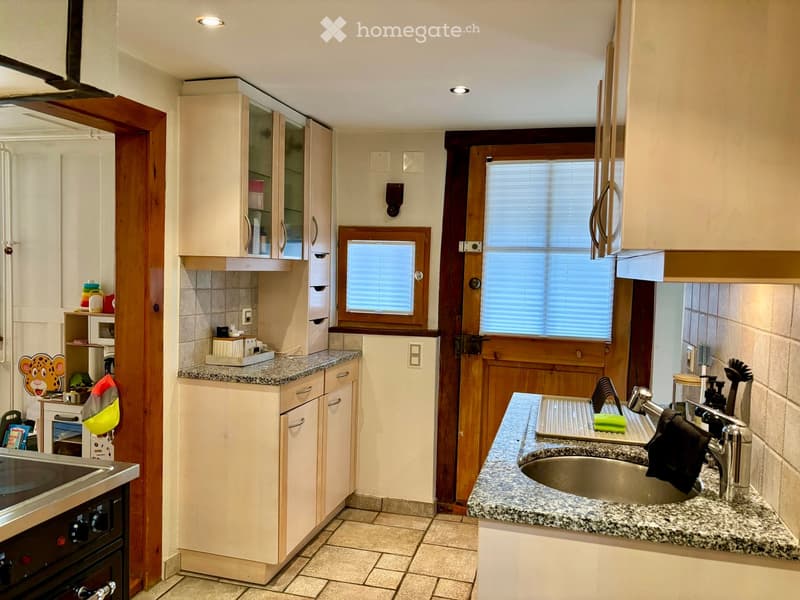 Modern kitchen with granite countertops, stainless steel sink, oven, microwave, and cabinets.