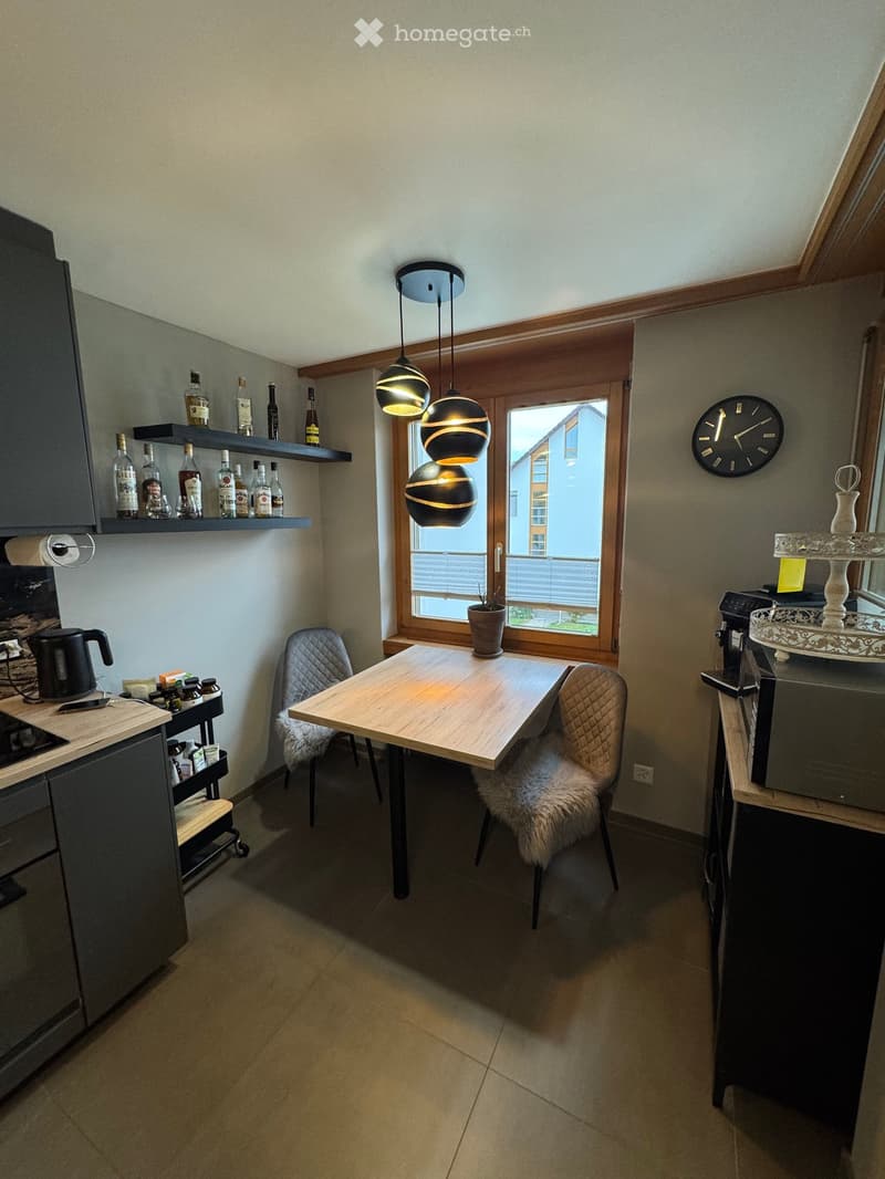 {"type": "Furnished Room", "objects": ["table", "chair", "pendant lights", "shelves", "bottle", "clock", "cupboard", "cupboard", "cupboard", "cupboard", "cupboard", "cupboard", "cupboard", "cupboard", "cupboard", "cupboard", "cupboard", "cupboard", "cupbo