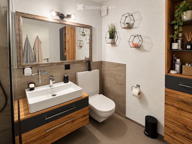 Modern bathroom with a white sink, wooden cabinet, toilet, large mirror, and decorative wall-mounted shelves with plants. Features include a sleek faucet, towel rack, and ambient lighting.
