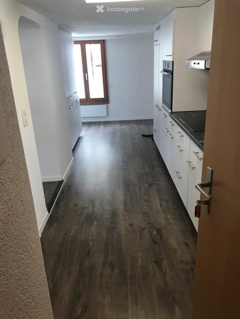 Empty room with wooden flooring, white walls, and a window with wooden frame. No furniture or equipment present.