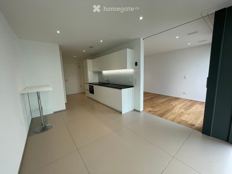 white cabinets, black countertops, stainless steel sink, faucet, electric oven, dishwasher, white tile flooring