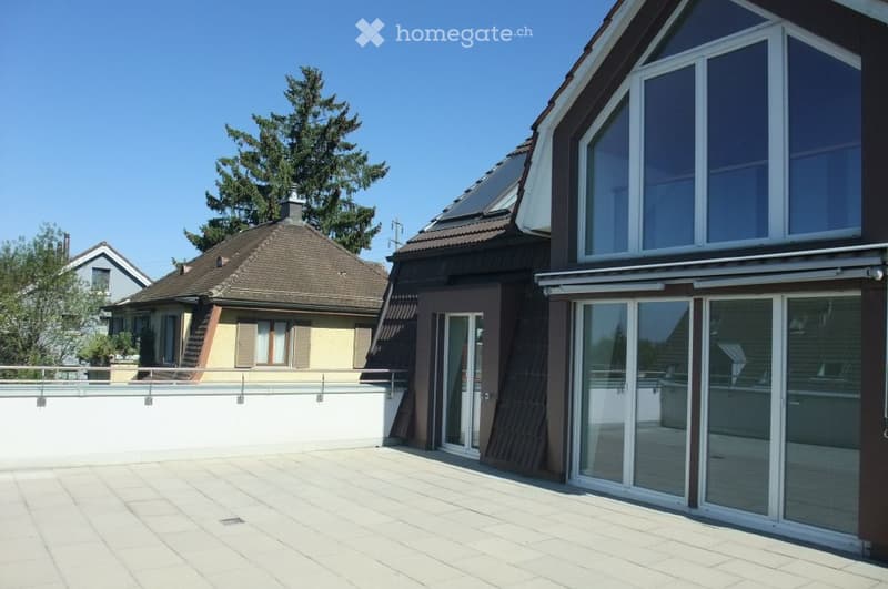 Modern two-story house with large windows, a tiled roof, and a swimming pool in the foreground.