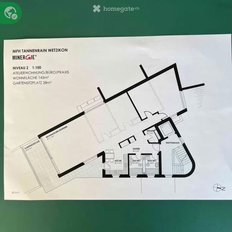 Floor plan of a 145m² apartment with a 28m² garden seating area, featuring a kitchen, bathroom, living space, and a staircase leading to a terrace.