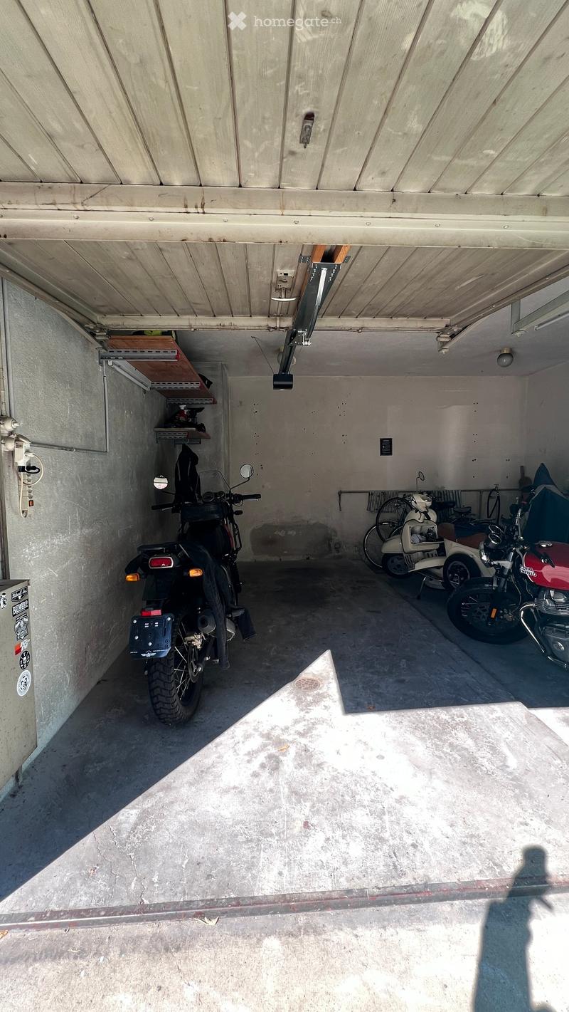 {"visible_features": ["Garage"], "type": "Garage", "objects": [], "description": "Garage with concrete floor and wooden ceiling, containing several motorcycles and a scooter, with shelves and storage items on the left side.", "localized_descriptions": {"E