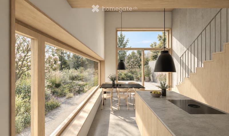 Modern kitchen and dining area with large windows overlooking a garden, featuring a dining table, chairs, pendant lights, and a countertop with a bowl and vase.