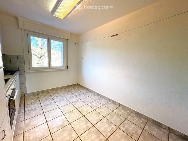 Empty room with tiled floor, white walls, and a window with blinds. No furniture or equipment present.