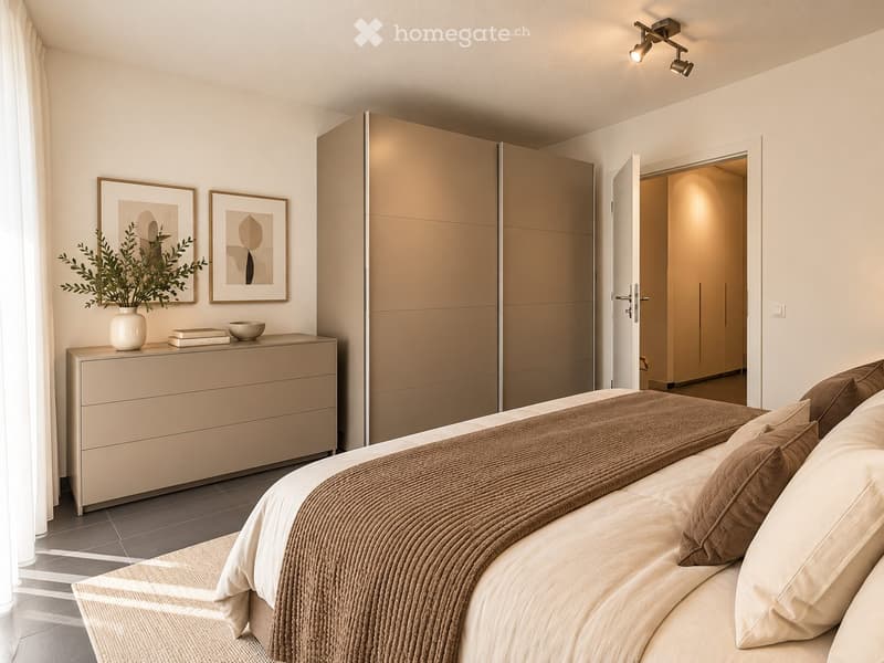 Modern bedroom with a large bed, nightstand, drawer, picture frames, vase with plant, bowl, and books on the nightstand. The room features a sliding wardrobe and warm lighting.