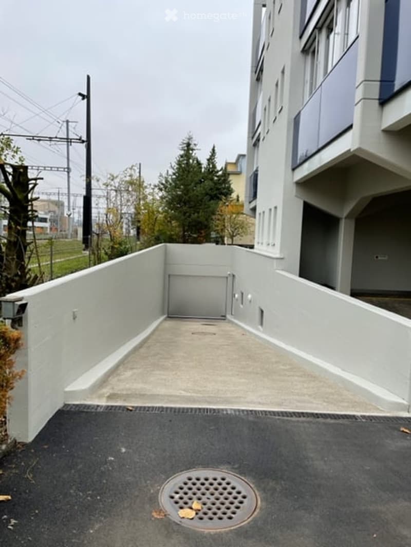 entrance to a garage in a multi-story building with a ramp
