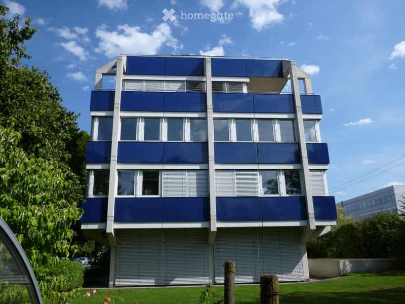 blue exterior, multiple floors, many windows, modern style