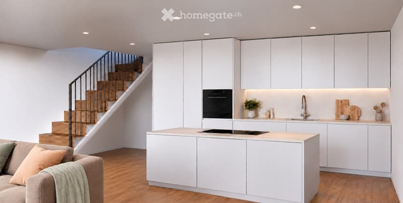 Modern open-plan living and kitchen area with white cabinets, a central island, a sofa, and a staircase leading to an upper level.