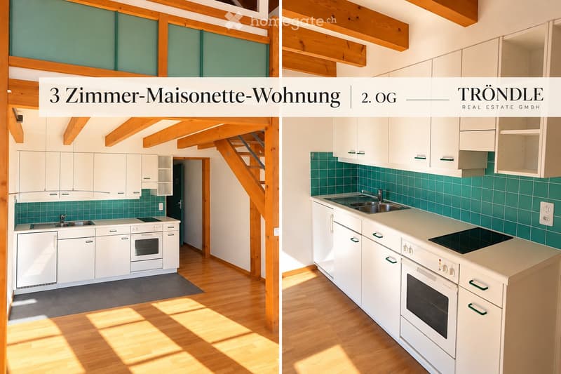Modern kitchen with white cabinets, stainless steel sink, and appliances, featuring green tiled backsplash and wooden flooring.