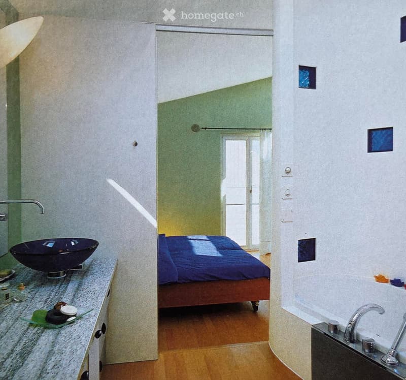 modern bathroom with sink, bathtub, wooden floor, white walls, corner bed, and open balcony door