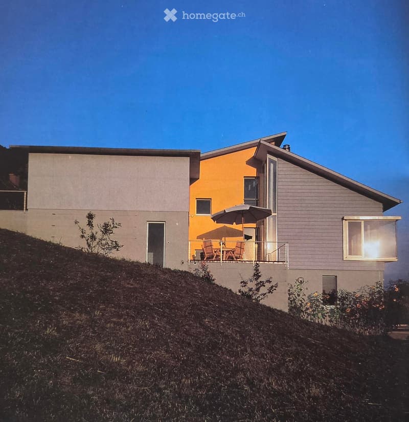 two story house, two parts, yellow and grey painted, terrace with table and chairs, located on hill
