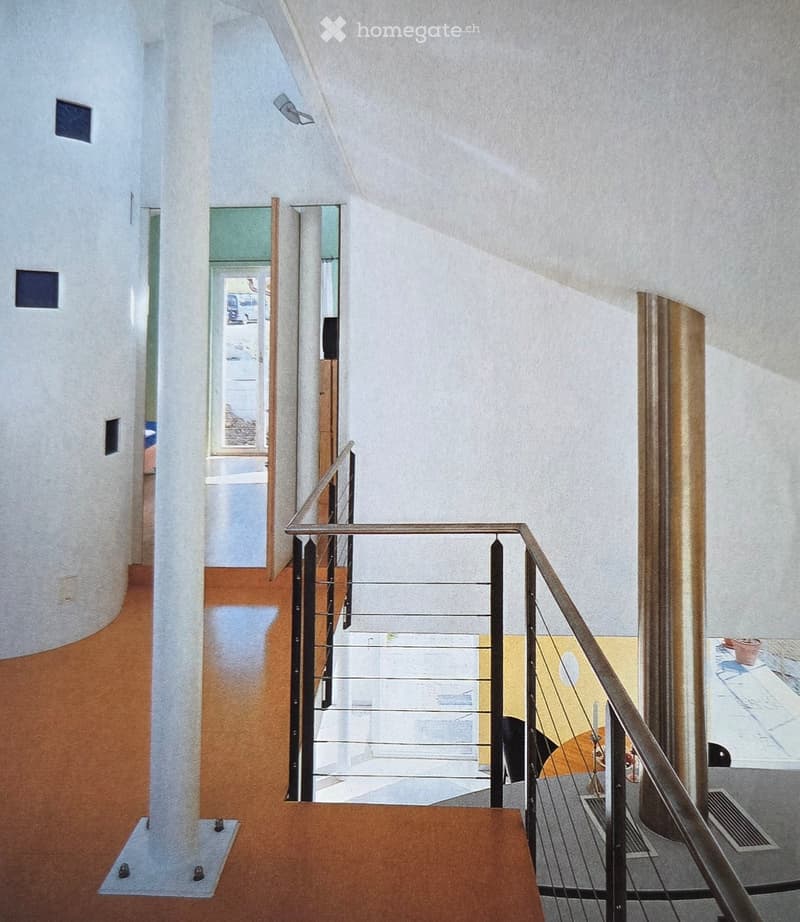 Interior shot with a staircase, a wooden door, and an open window showing a hallway leading to another room. The hallway has a metal railing and carpeted floor.