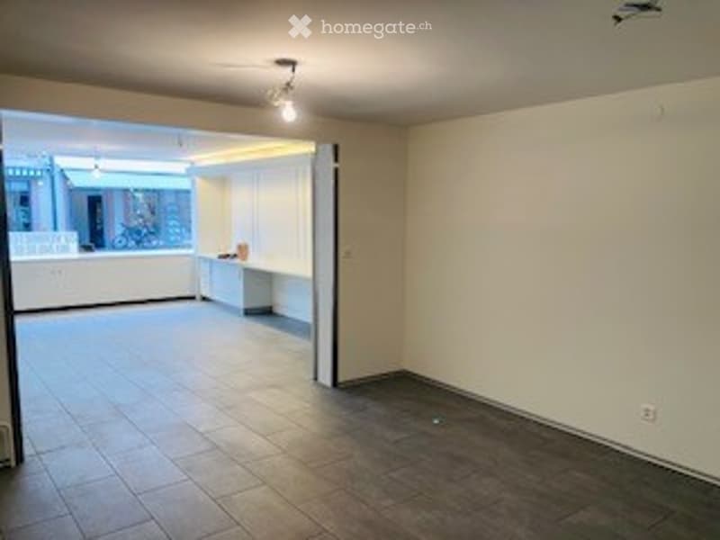 Empty room with tiled floor, white walls, and a single window. No furniture or equipment present.