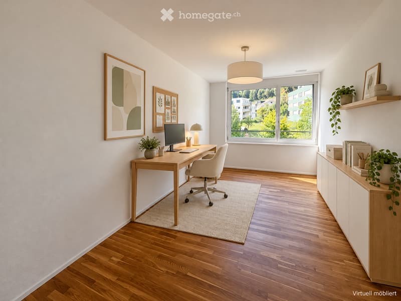 A modern, well-lit home office with a wooden desk, ergonomic chair, computer screen, and a hanging pendant light. The room features light-colored walls, wooden flooring, and a large window offering a view of greenery.